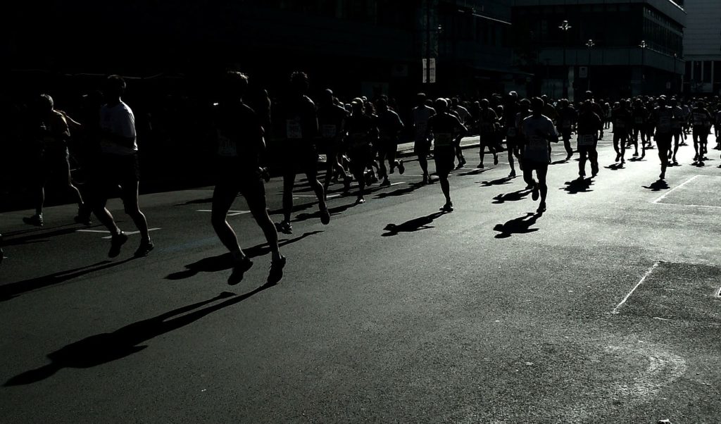 Half Marathon Pacing Strategy - Silhouettes of runners in a race 