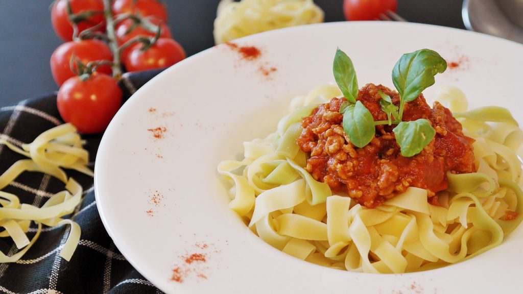 Bowl of pasta with red sauce and garnish