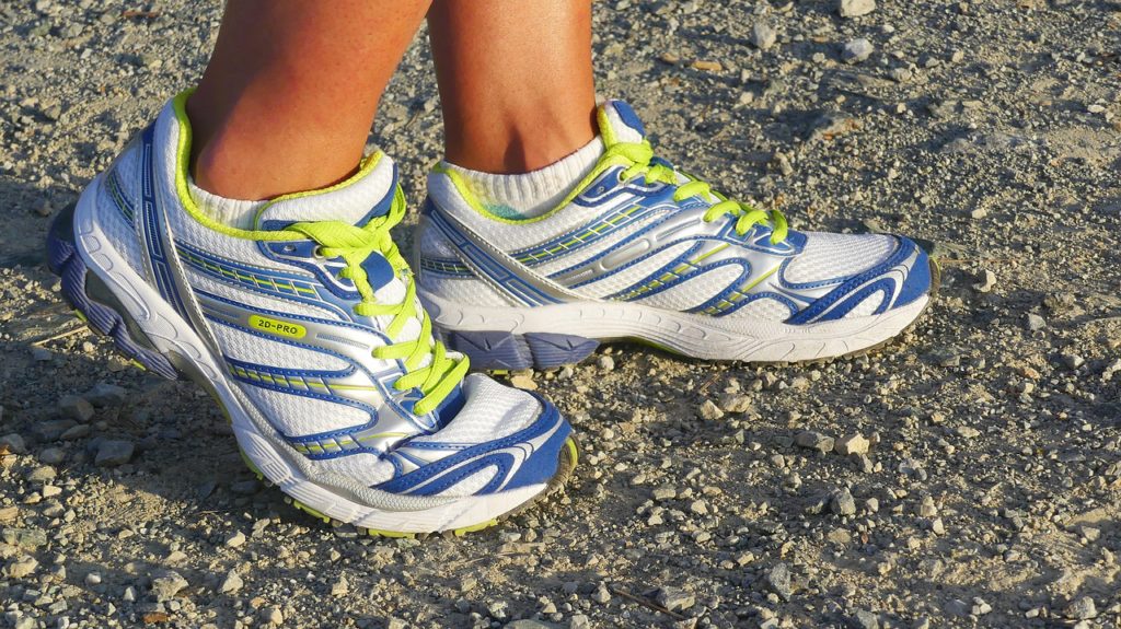 Half Marathon Workouts - runner in blue, yellow, and silver shoes.